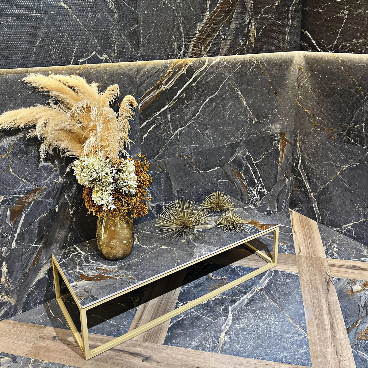 La Platera Dusk 'Black', zwarte marmerlook wand met reliëfuitvoering erboven, gouden bijzettafel en houten vloer