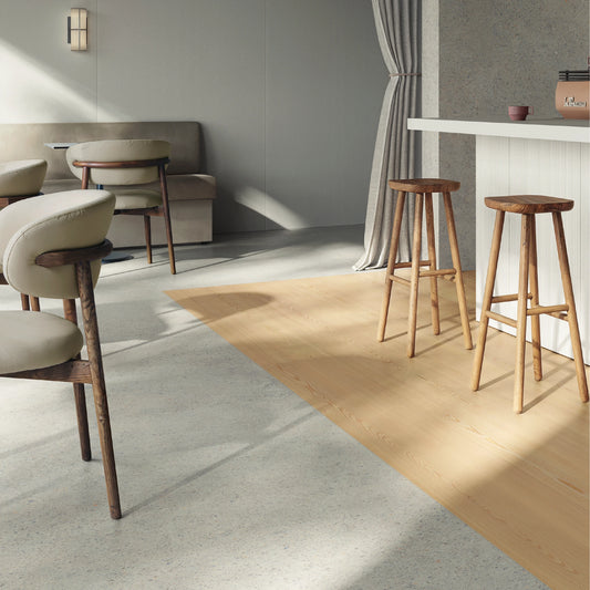 Casalgrande Padana Elements Pebbles 'Grey', lichtgrijze vloertegels 120x120cm en 120x278cm in een eethoek met barkrukken