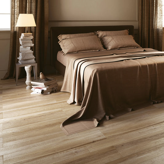 Castelvetro Aequa 'Tur', houtlook vloertegels 13x80cm en 20x80cm door elkaar in een slaapkamer met bed en leeslamp