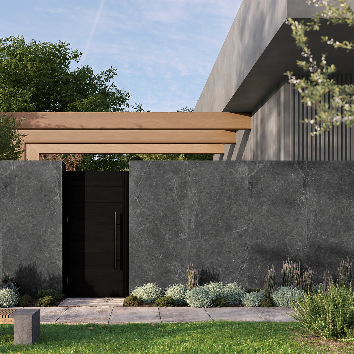 Keraben Bleuemix 'Black Soft', antracieten wandtegels als tuinmuur met een zwarte deur en lage beplanting