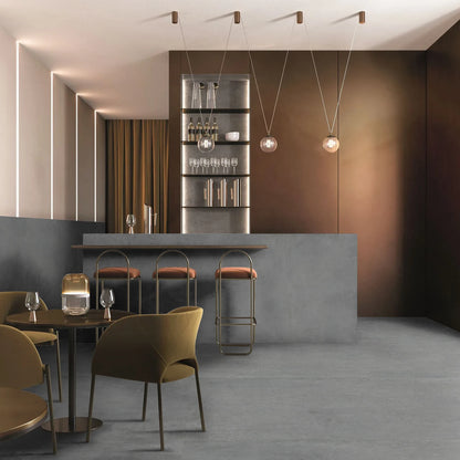 EnergieKer Corsocomo 'Drop', hier als vloer in 120x120 in een bar met barkrukken en gouden stoelen