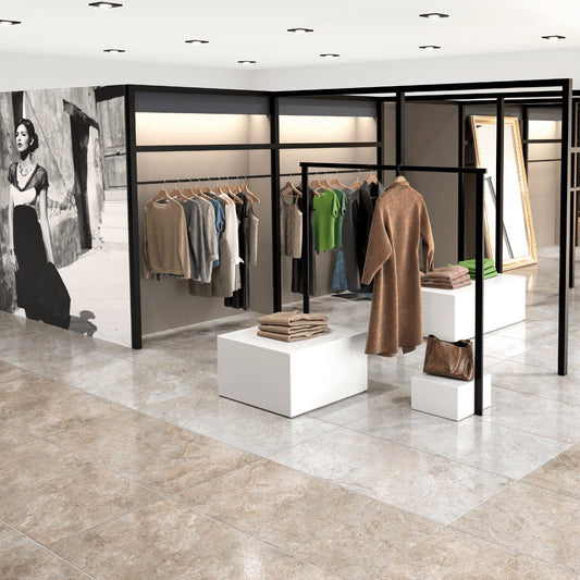 Tuscania Dolomia Stone 'Almond', beige natuursteenlook vloertegels met zachte glans in een kledingwinkel met zwarte rekken