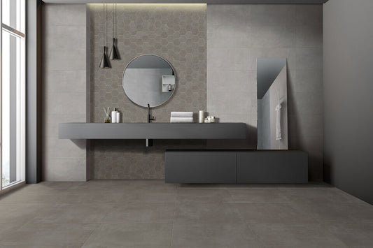 Ceramica Valsecchia Galaxy 'Dark', grijze betonlook wand- en vloertegels in een badkamer met wastafelblad en ronde spiegel
