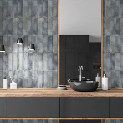 Estudio Cerámico Hackney 'Grey', grijsblauwe wandtegels verticaal gezet achter een houten wastafelmeubel met zwarte waskom