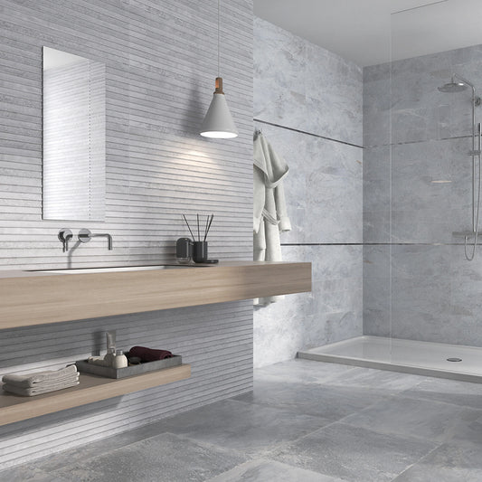 Keraben Nature 'Concept Grey', grijze wandtegels 30x90 met lijnendecor naast vlakke tegels in een badkamer met douche