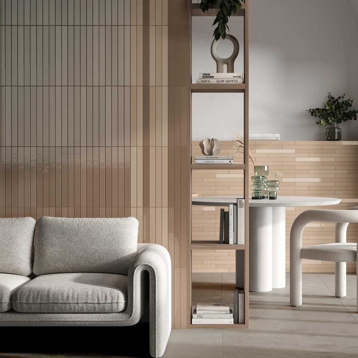 Keradom Twiggy 'Nudo', beige wandtegels in mat en glans achter een bank, met open boekenkast en ronde eettafel